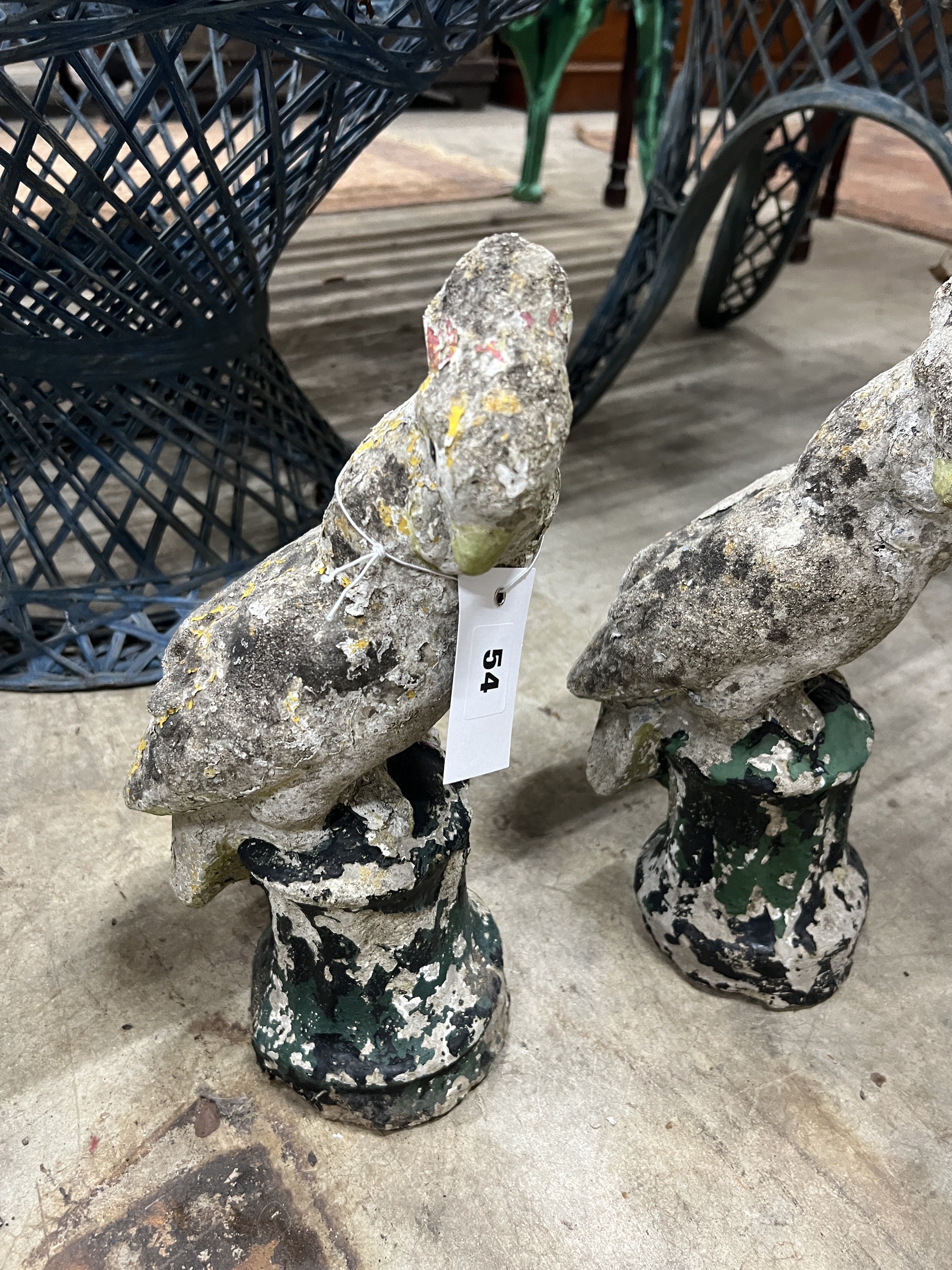 A pair of reconstituted stone parrot garden ornaments, height 32cm